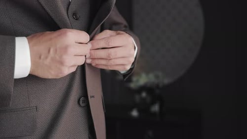 Groom Adjusting His Suit Jacket Before the Wedding A Closeup Image of a Groom's Hands Adjusting the