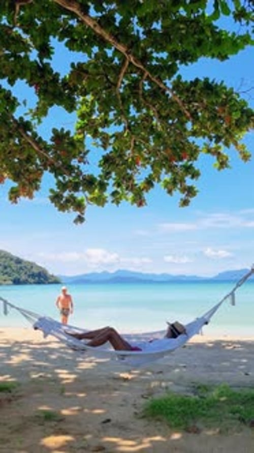 a Woman is Laying in a Hammock on the Beach Koh Mak Island Thailand