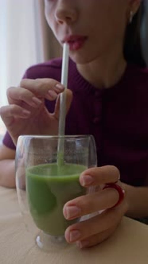 Young Woman Drinking Fresh Green Detox Smoothie