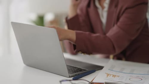 Business Woman Works at Desk on Laptop and Phone