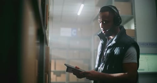 Warehouse Employee in Headset Working in Delivery Service of ECommerce Store