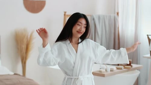 Woman in Robe Dancing in Bathroom with Style