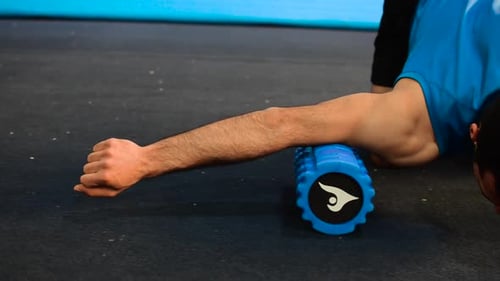 Man Foam Rolling Upper Arm and Shoulder