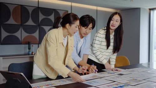 Team Discussing Data in Modern Office Environment