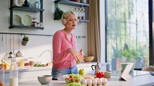 Woman in Kitchen Dances and Prepares Food