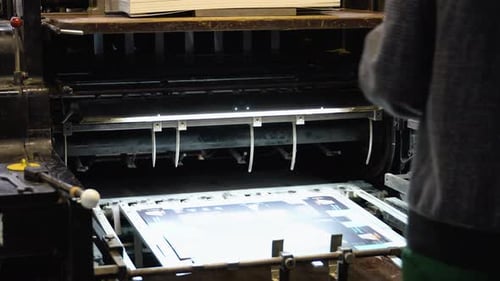 Printing Machine Works Rolling Printed Newspaper in Typography Facility
