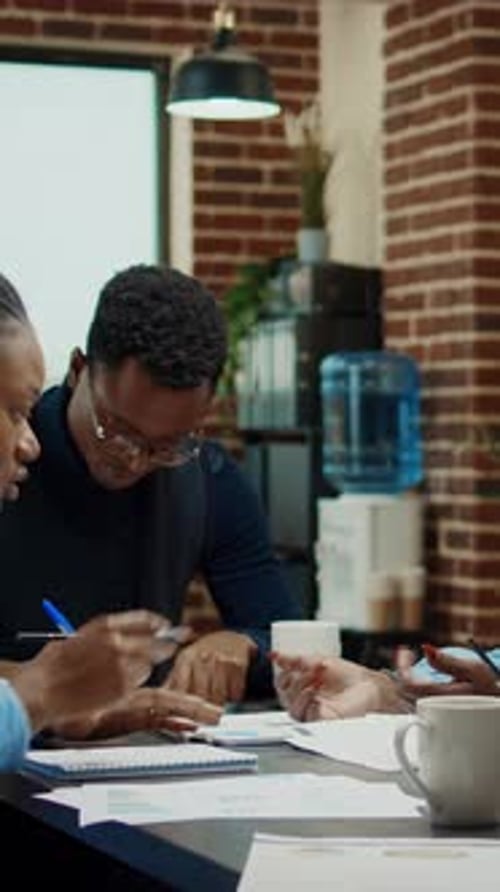 Colleagues Collaborate at Office Meeting