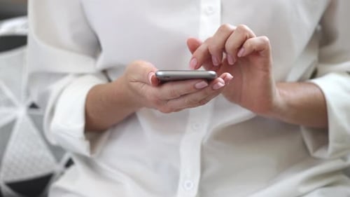 Woman Typing Message on a Smartphone