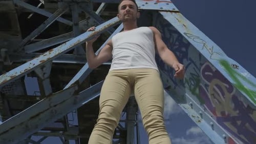 Young Adult Male Doing a Flip on Bridge