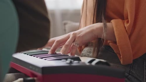 Girl Playing Synthesizer at Home Music Studio
