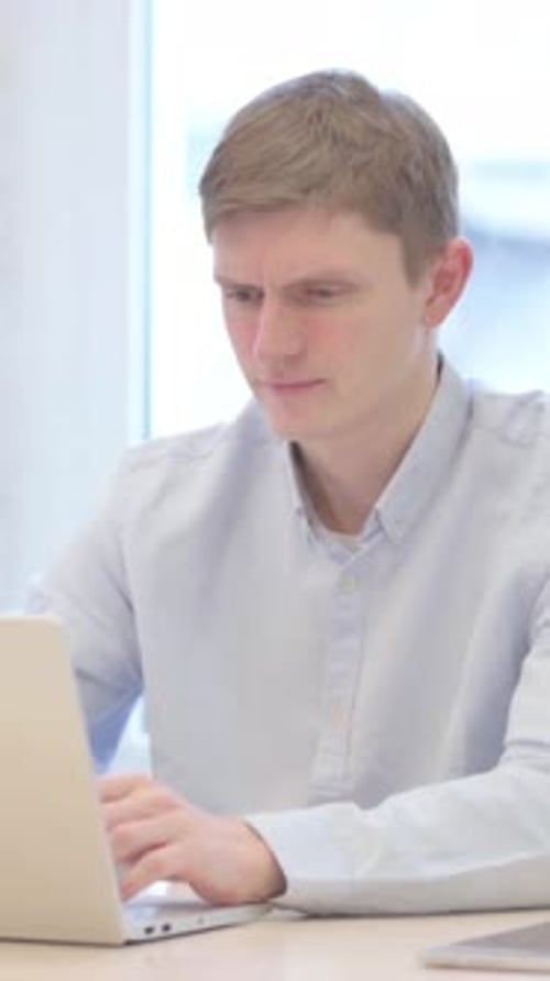 Young Businessman Reacting to Loss While Working in Office, vertical video