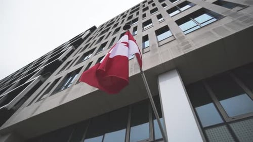 Canadian Flag Waving with Building Facade Background