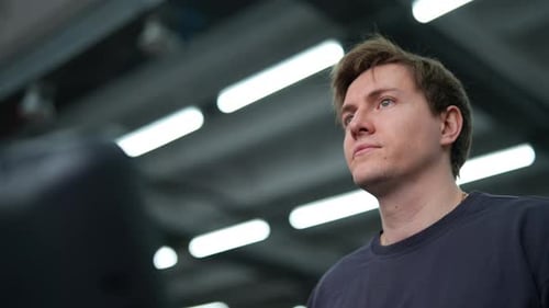 Closeup Face of Handsome Athletic Man Walking on Treadmill Preforming Warmingup Run Routine Exercise