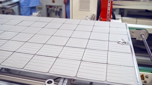 Solar panel moves on a conveyor belt in the robotic factory.
