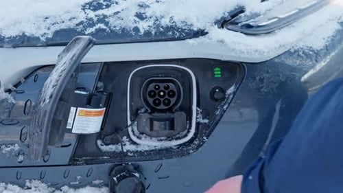 Electric Car being Unplugged During Winter