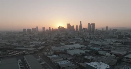 a city skyline with a sunset