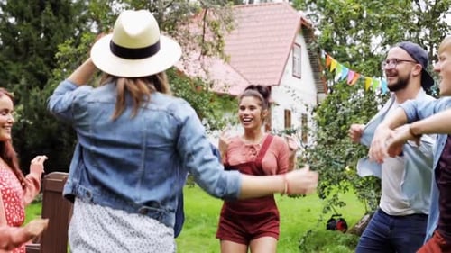Happy Friends Dancing Together Outdoors in Yard
