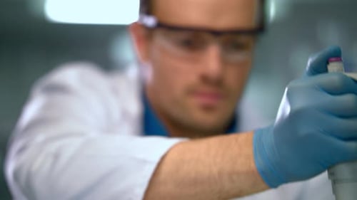 Lab Researcher Using Pipette for Scientific Experiment