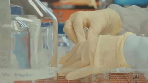 Medical Researcher Working with Pipette in Laboratory