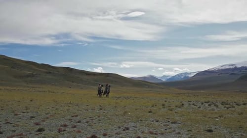 Kazakh eagle hunters riding on tribe horses in Mongolia Altai Mountains