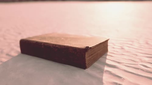 Old Book on the Sand Beach