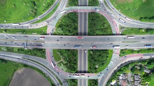 Aerial huge multi-lane circle roundabout intersection in city traffic highway. Public transport