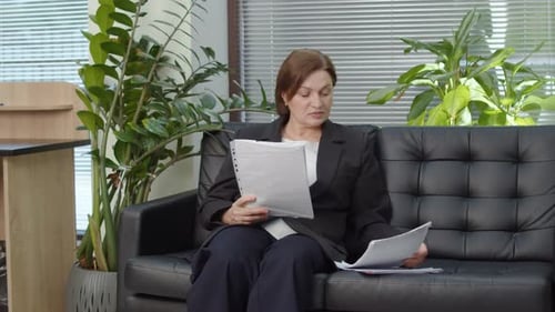 Businesswoman Reviewing Documents in Office