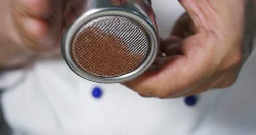 Chef Using Sifter to Dust Powder