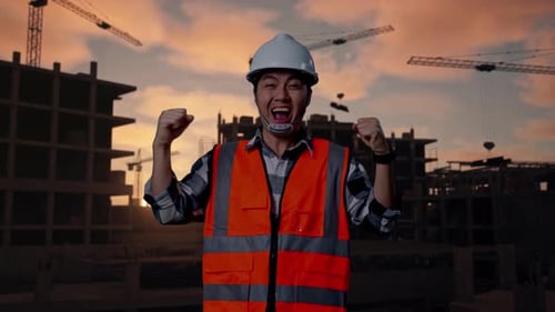 Asian Male Engineer Screaming Goal Celebrating Working At Building Site