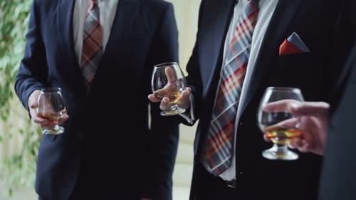 Business People Raising Toast with Whiskey at Office