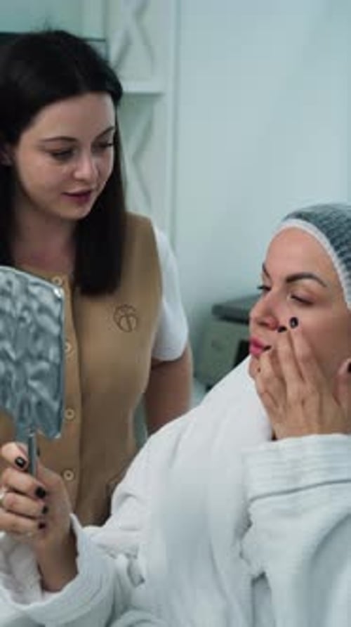 Woman Examining Cosmetic Treatment Results with Esthetician