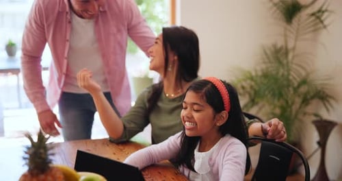 Happy Family Uses Tablet at Dining Table