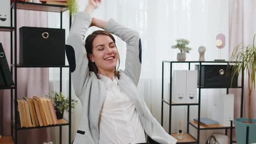 Smiling Woman Relaxing after Typing on Laptop