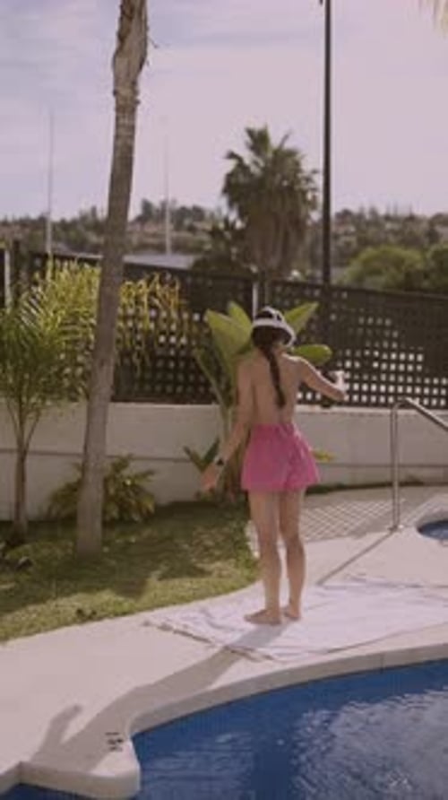 Woman Exercises with VR Headset by Pool