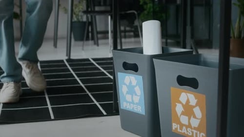 Close Up of Office Worker Throwing Paper into Recycling Bin