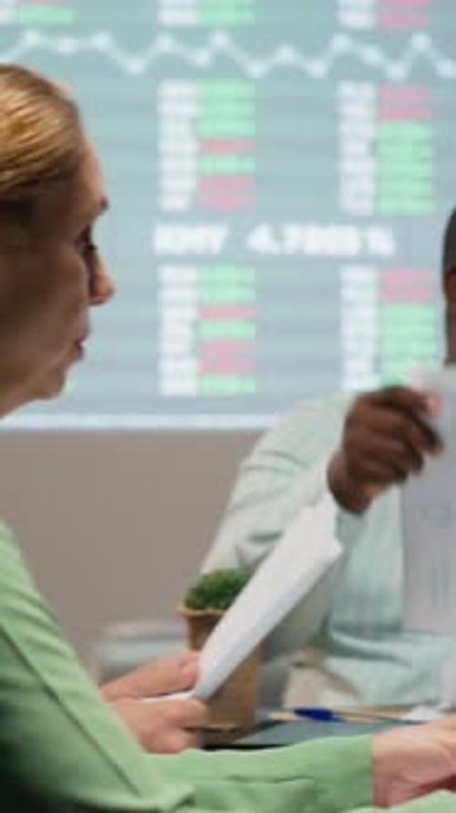 Vertical Video Diverse Professionals Group Evaluating Files and Performance Indicators
