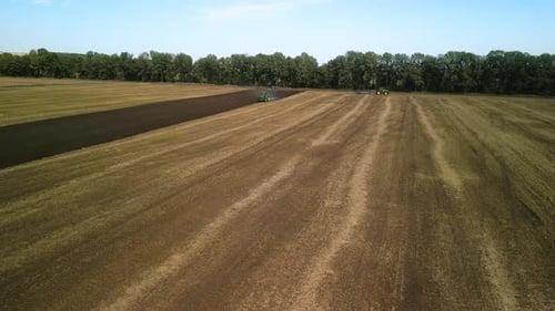 Tractors plowing the field in Ukraine