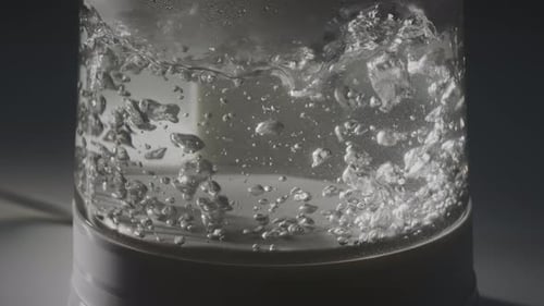Water Bubbling in Transparent Electric Kettle Close Up
