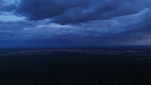 Dramatic aerial rural landscape footage, stormy sunset with twilight contrast
