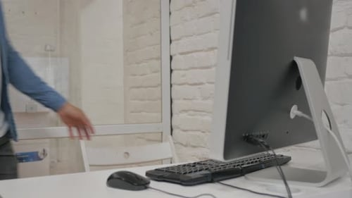 African Man Coming Office to Work on Computer