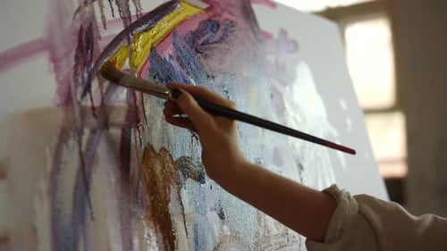Closeup Woman Hand Making Brush Stroke on Canvas Indoors. Creative Painter Holding