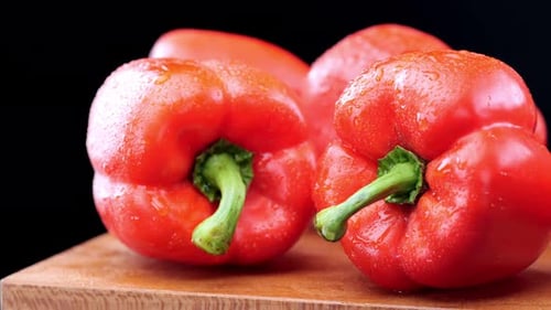 Fresh, Wet, Red Bell Peppers on Wood