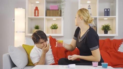 Woman Caring for Sick Man at Home