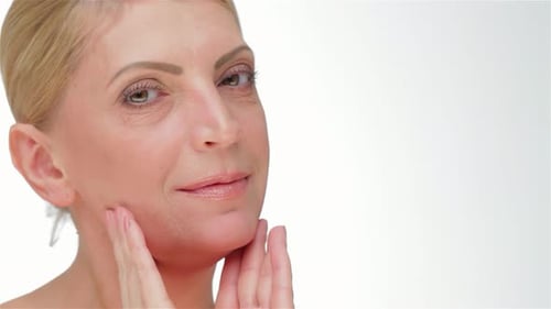 Woman Examines Face and Skin in Close Up