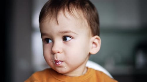 Adorable Child Eating Messily at Home