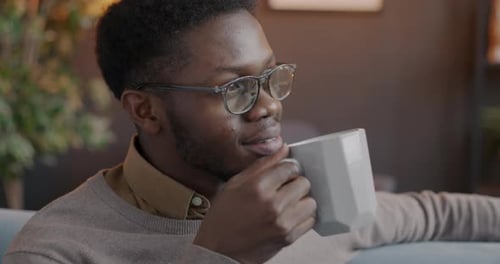 Young Adult Drinking Coffee from a Mug