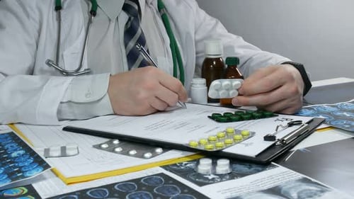 Doctor Writing Prescription with Pills and Medication