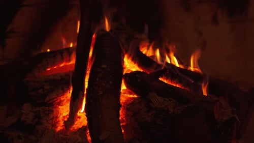 Burning Fireplace Logs with Flickering Flames Indoors