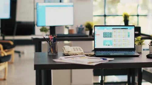 Stock Market Diagrams with Charts and Stock Figures on Laptop Sitting on Desk