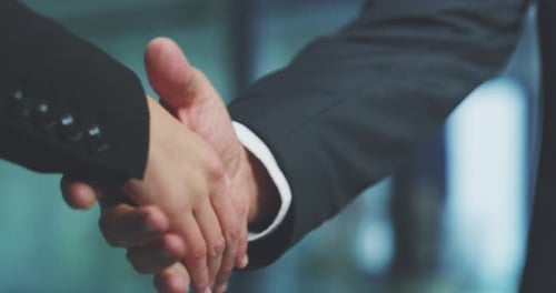 4k video footage of two unrecognizable businesspeople shaking hands in the office